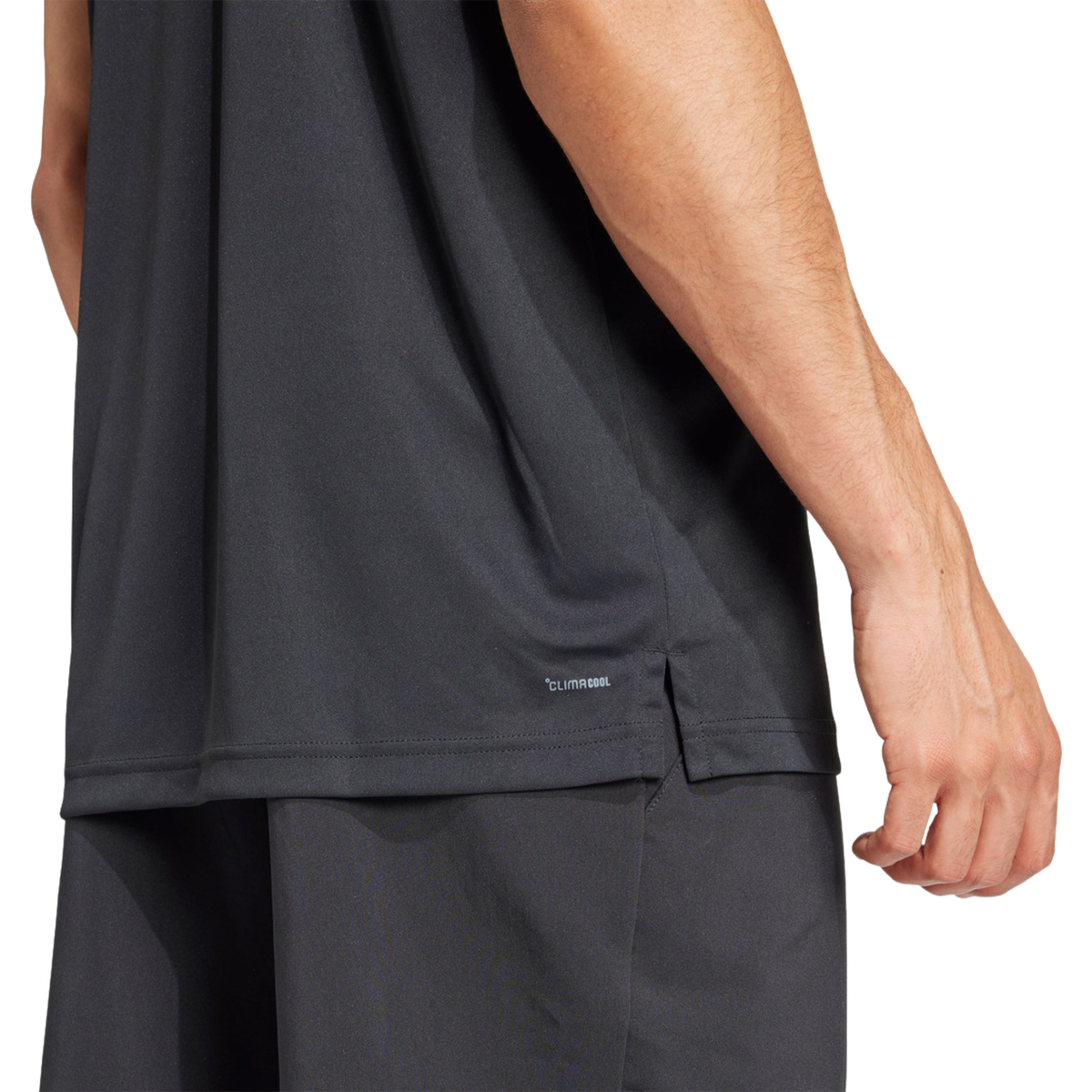 Close-up of the CLIMACOOL detail and side slit of the black adidas polo shirt.