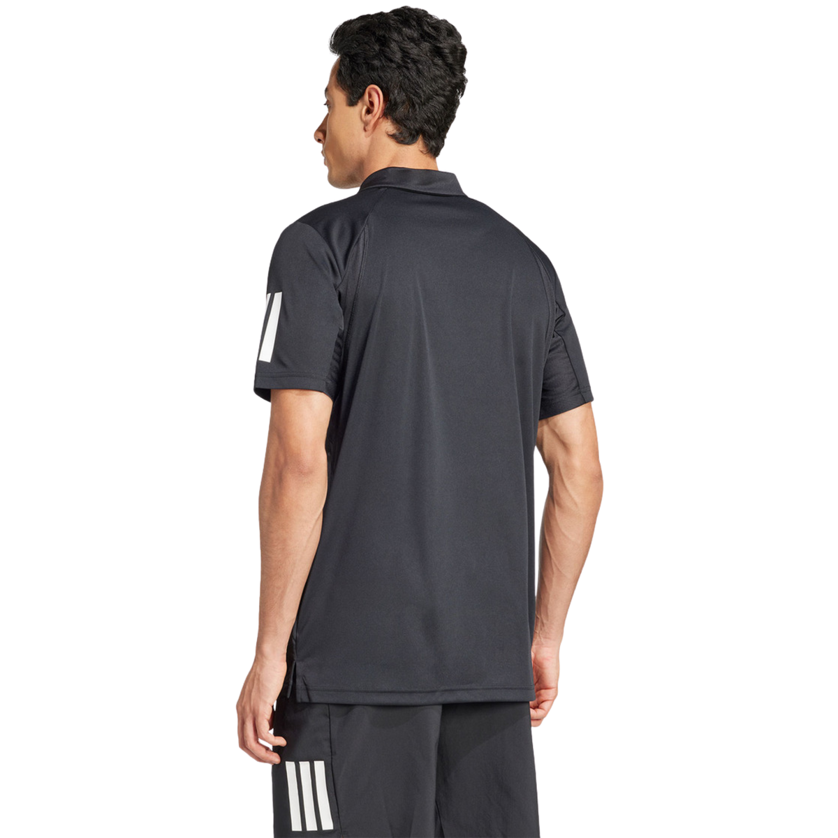 Back view of a model wearing the black adidas polo shirt.