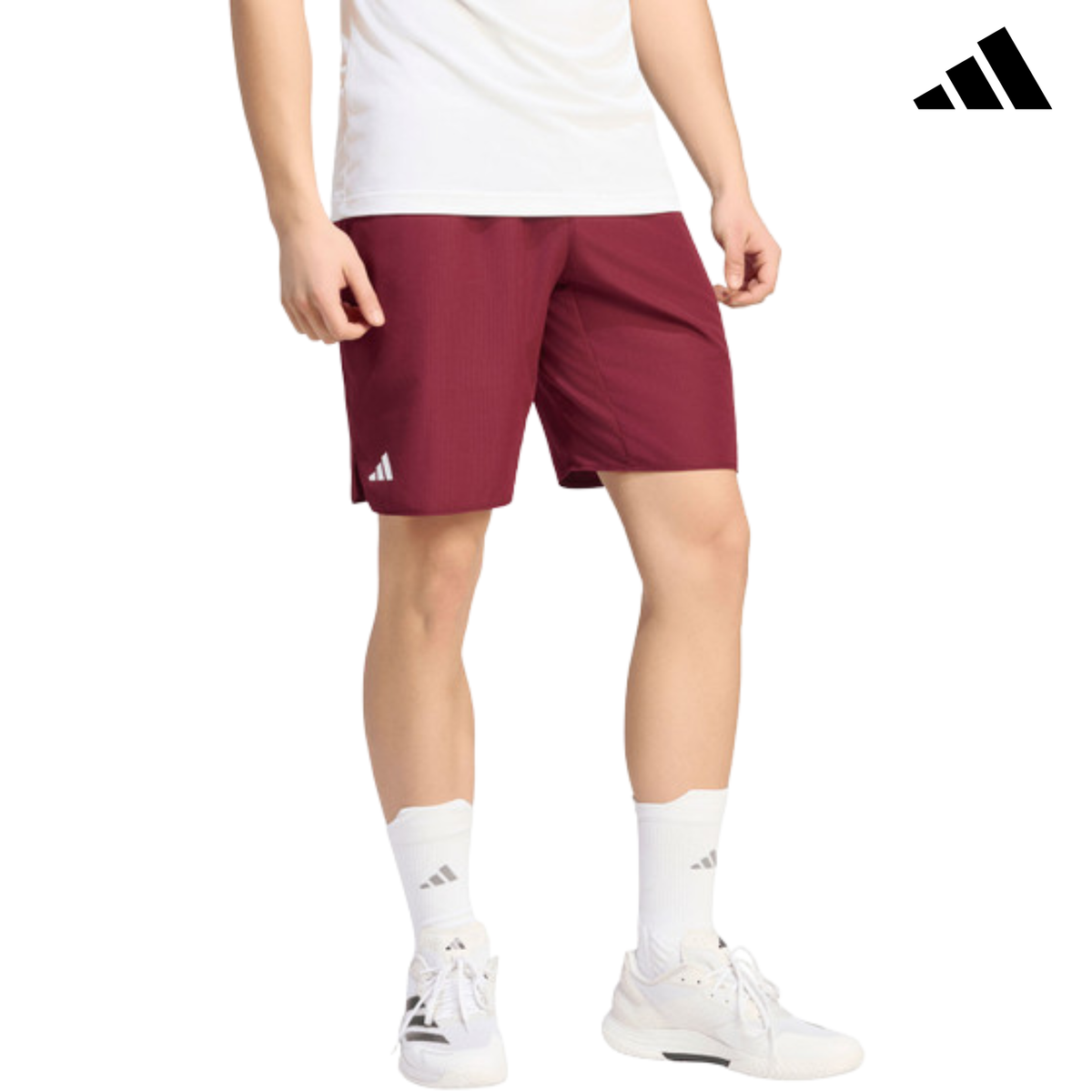 Front view of a model wearing the burgundy adidas Club Short KS8299 with adidas logo.