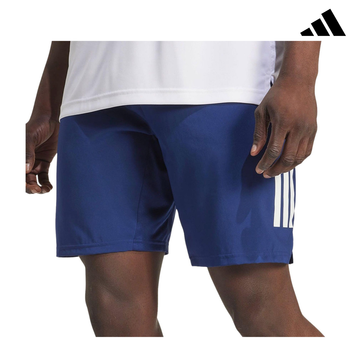 Front view of a model wearing the blue adidas men's shorts with adidas logo.