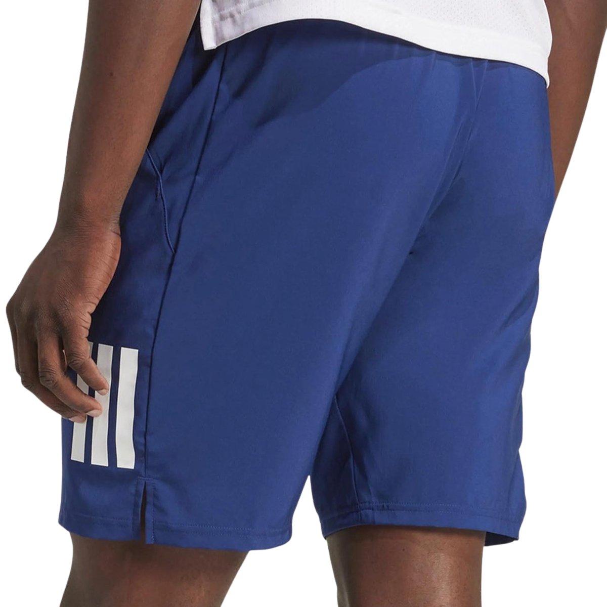 Side view of a model wearing the blue adidas men's shorts showing the three-stripe design and side slit.