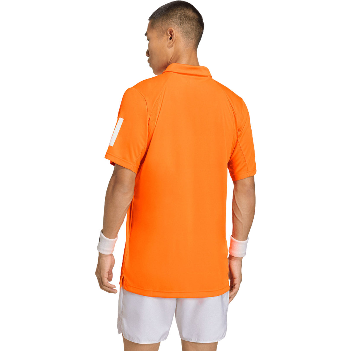Back view of a model wearing the orange Adidas polo shirt.
