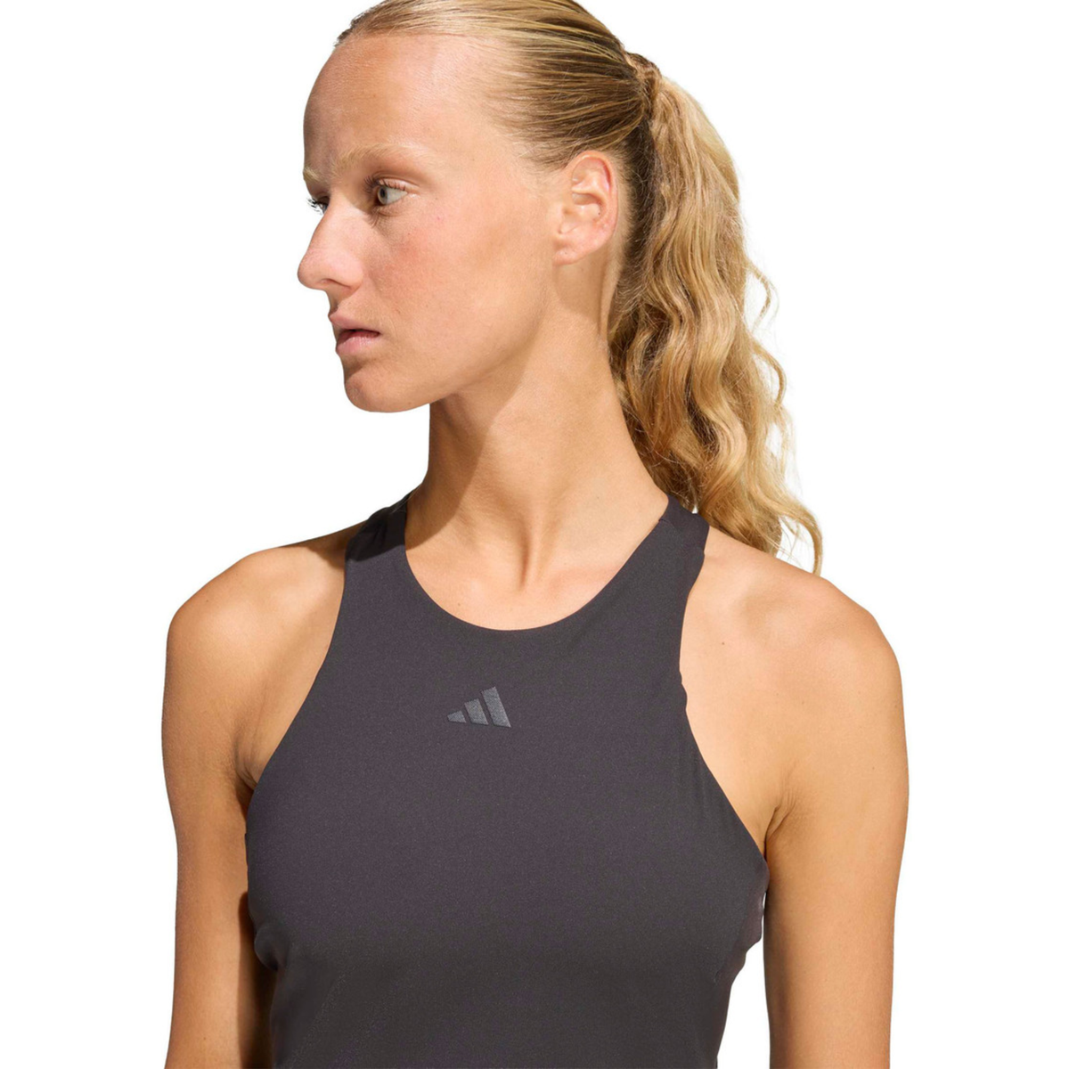 Close-up front view of a model wearing the black adidas women's tank top.