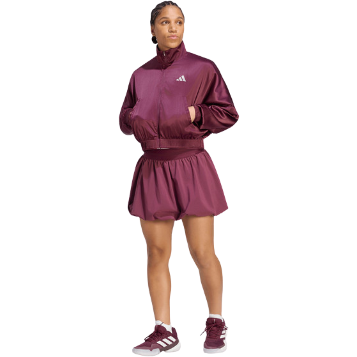 Full-body front view of a model wearing the purple adidas women's skirt.