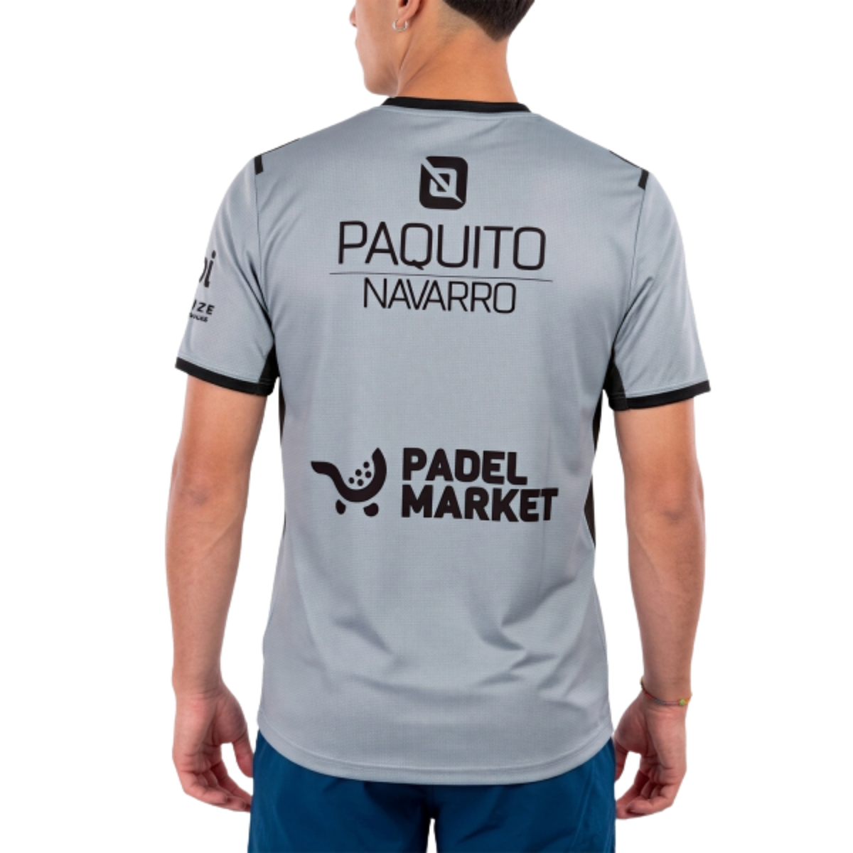 A back view of the Bullpadel Mensa PN Grafito Vigoré men's padel T-shirt, showing the grey fabric and Paquito Navarro signature detail.
