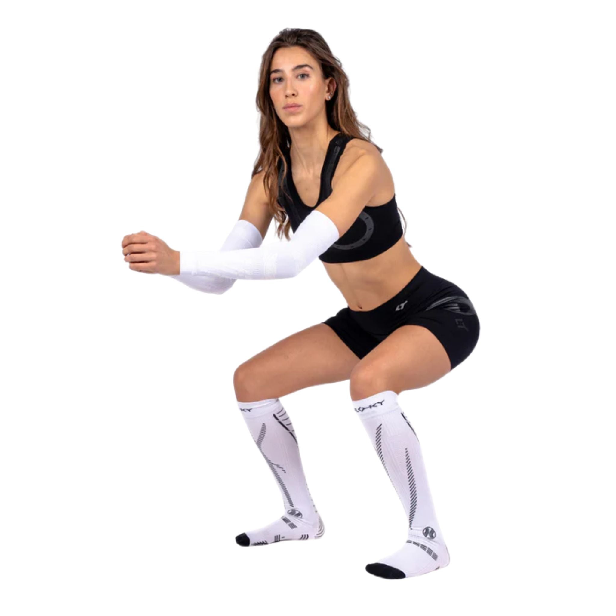 Female athlete wearing the Floky GRF Long Socks White, demonstrating ergonomic fit, compression