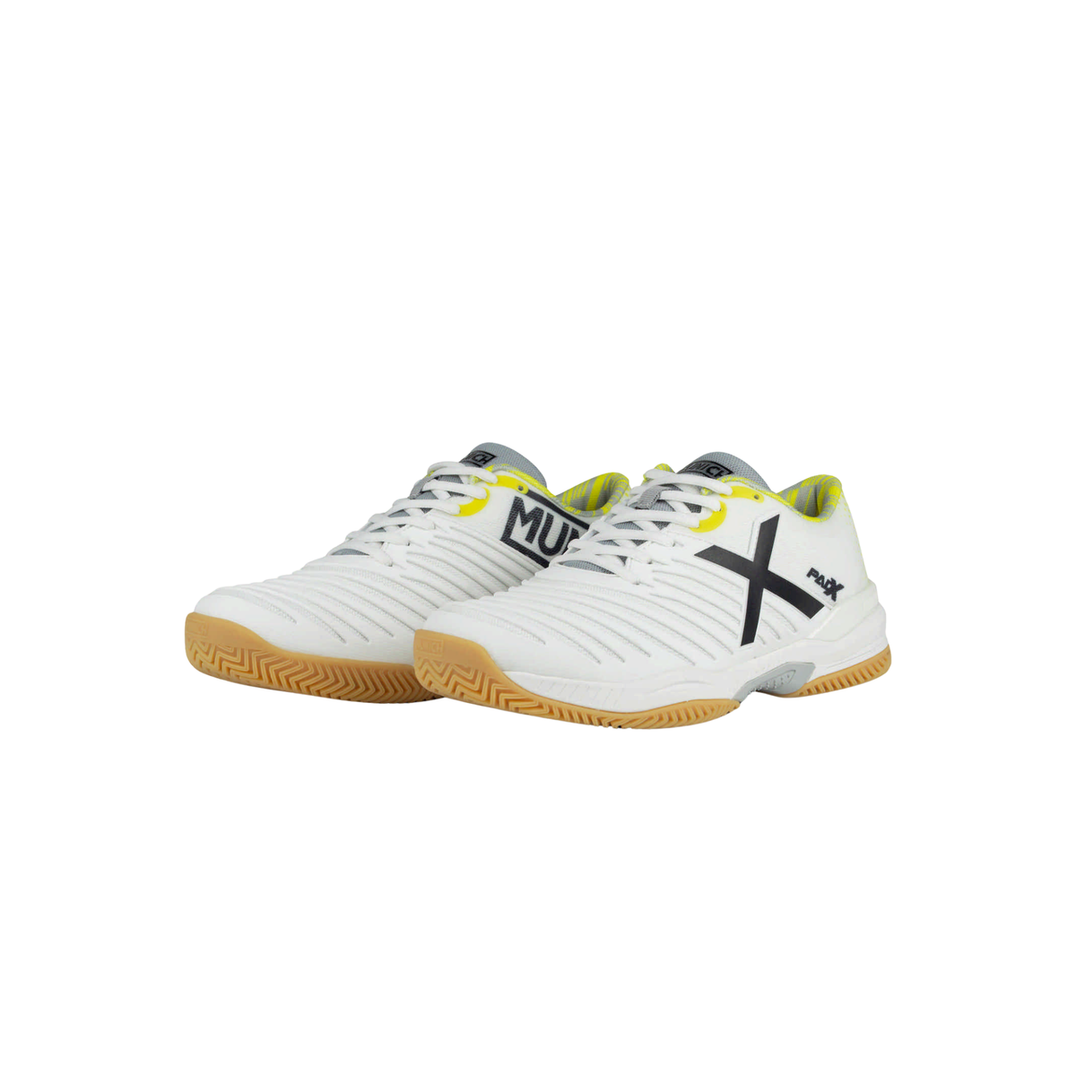 Pair of Munich PADX 67 padel shoes in white with black and yellow details, shown from an angled front view with white laces, ribbed uppers, black Munich and X branding, yellow collar accents and gum outsoles.