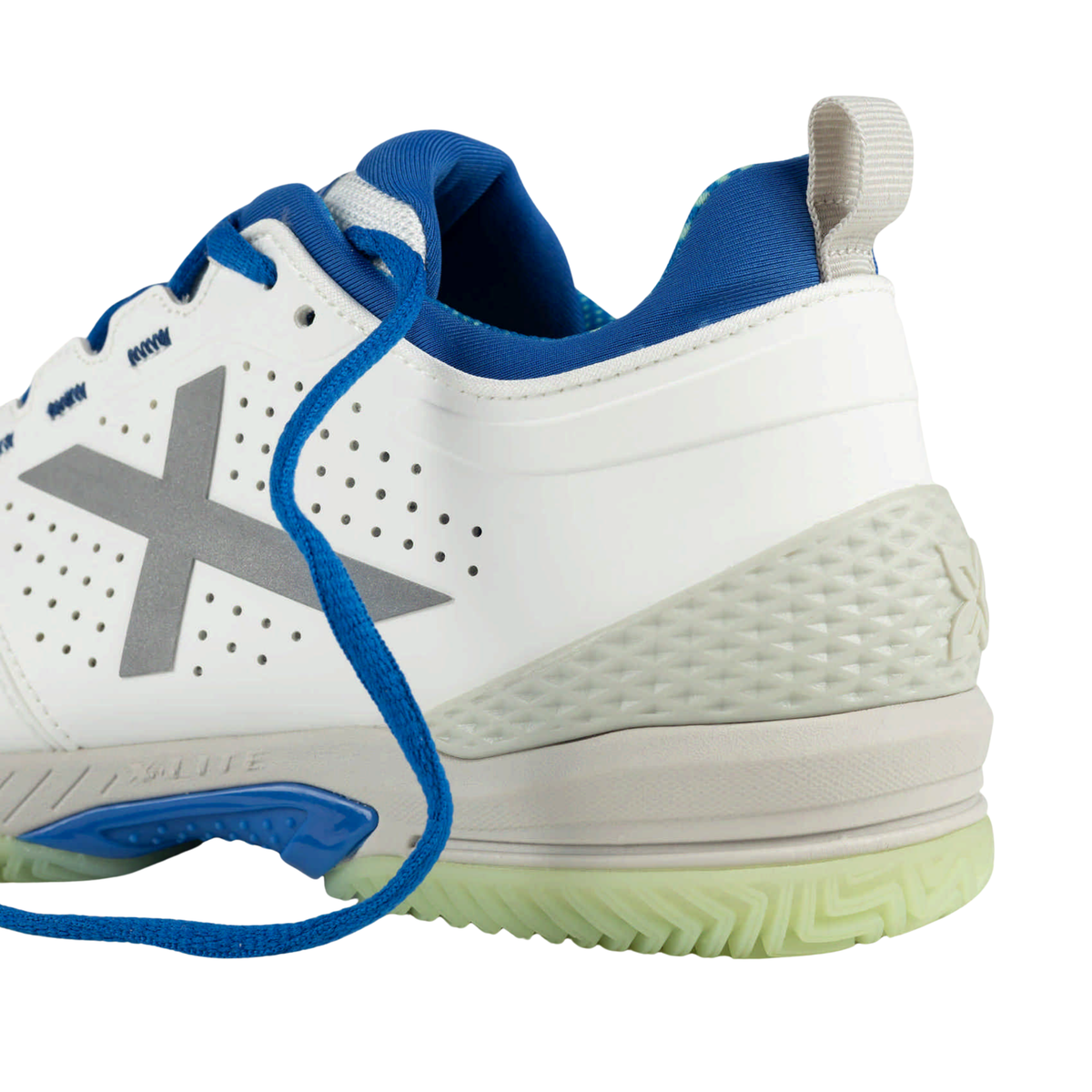 Close-up of the rear side and heel of the Munich Atomik 53, highlighting the white upper, blue padded lining and laces, silver X logo, perforations, grey pull tab, textured heel reinforcement and pale green outsole.