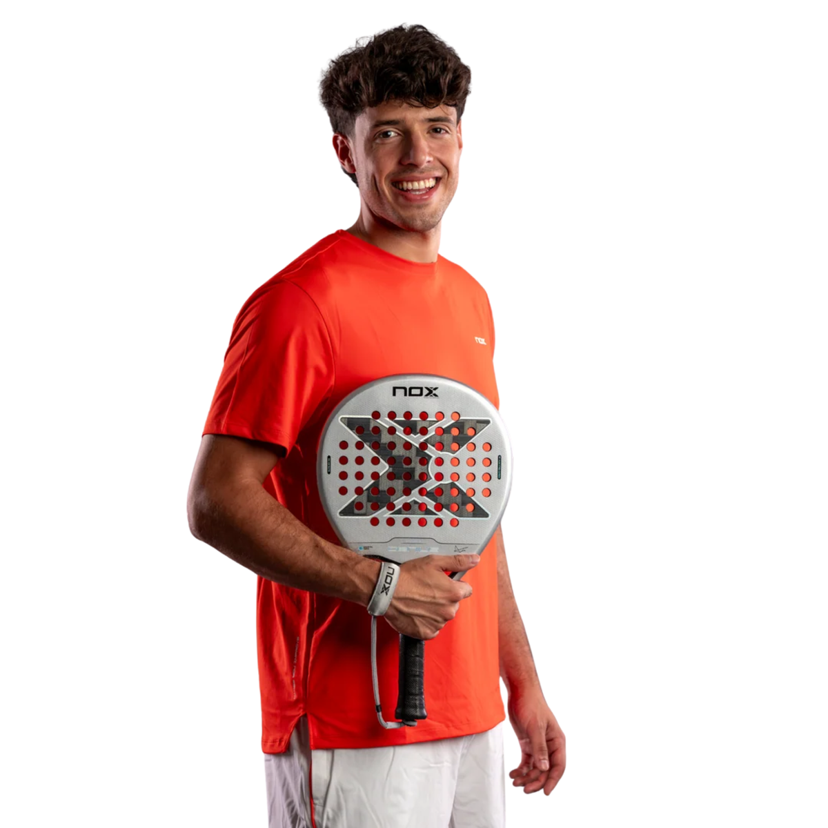 Male padel player holding the Nox AT10 GENIUS 12K ALUM Xtreme 2027 racket on a light background.