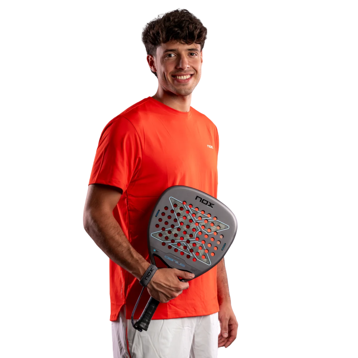 Professional padel player Agustín Tapia holding the Nox AT10 GENIUS ATTACK 18K ALUM 2027 racket while wearing a red Nox shirt.