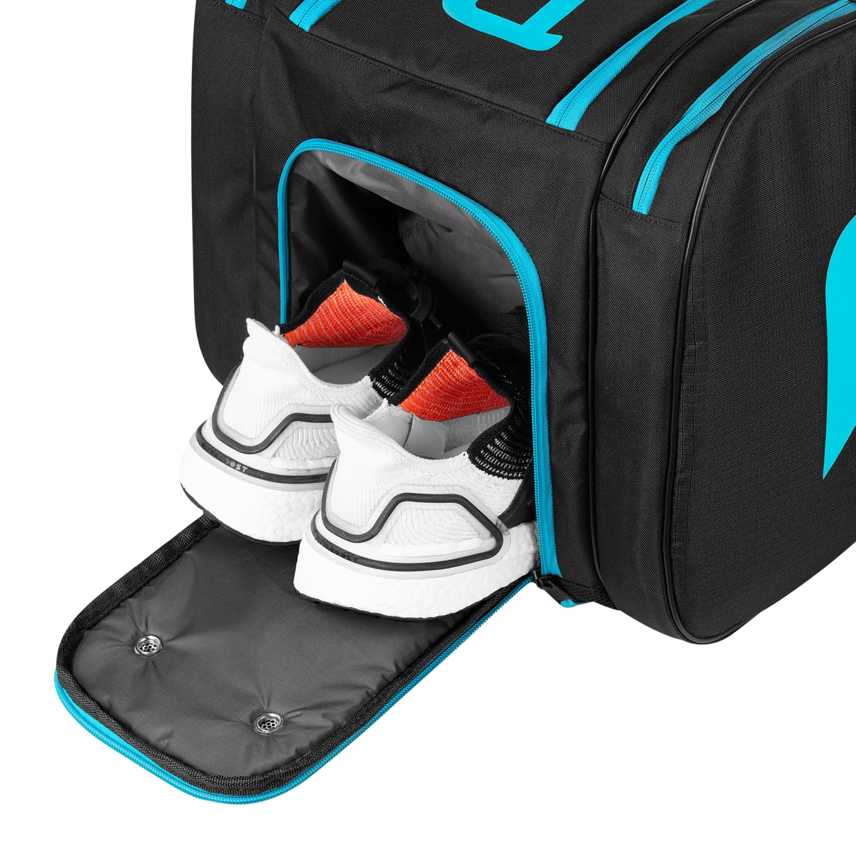 Open shoe compartment of the Pallap Mid Racket Bag with a pair of shoes inside.