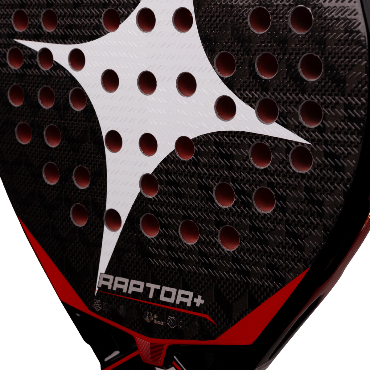 A close-up of the StarVie Raptor+ Red racket face, showing the textured carbon surface, perforations and red graphic details.