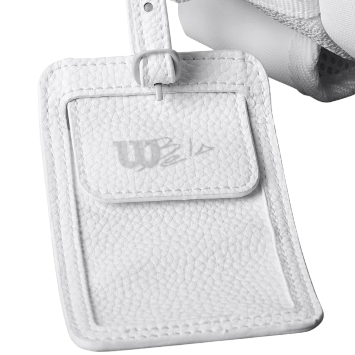 Close-up of the white Wilson Bela padel bag luggage tag featuring the Bela logo and textured finish.