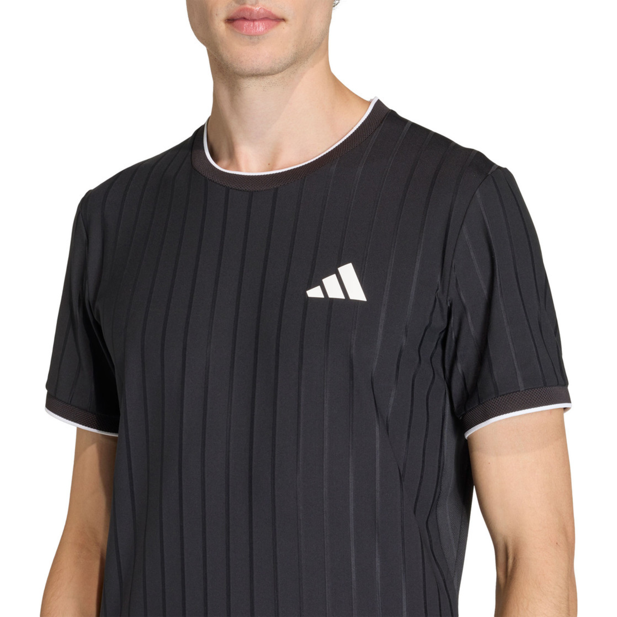 Front upper-body detail of the adidas Climacool Freelift Pro T-Shirt Black KG6053, featuring тонal vertical striping, white adidas chest logo and contrast trim at the collar and sleeve edge.