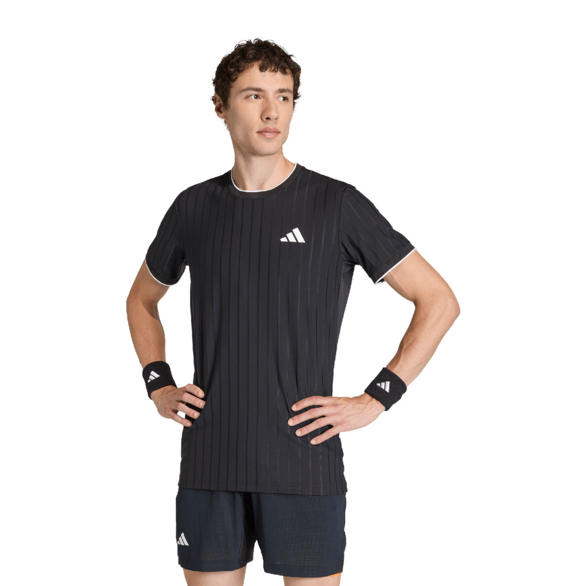 Male model posing in the adidas Climacool Freelift Pro T-Shirt Black KG6053, highlighting the athletic fit, fine vertical stripe pattern and white adidas logo on the chest.