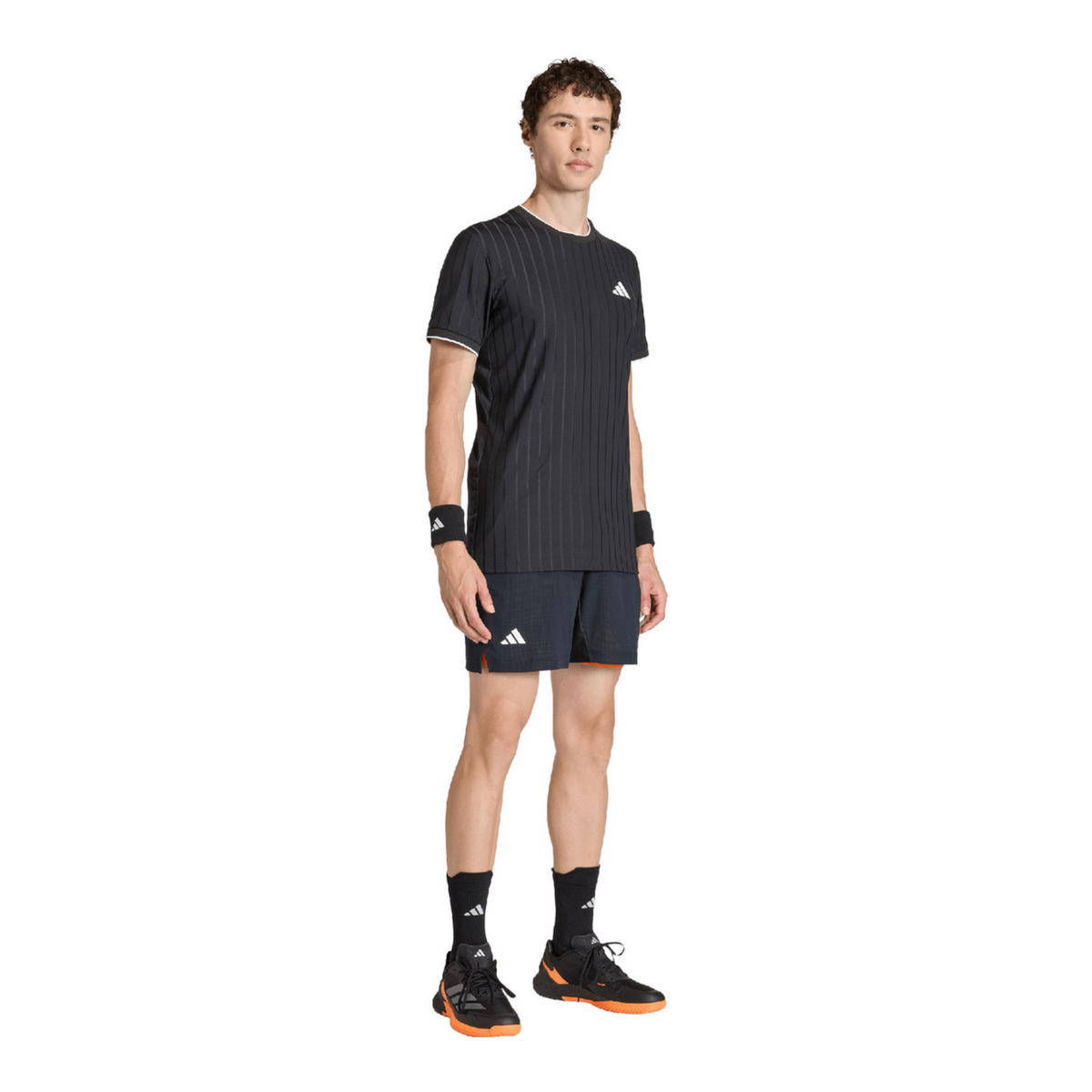 Male model wearing the adidas Climacool Freelift Pro T-Shirt Black KG6053 in a side outfit view, paired with dark shorts, black socks and black adidas court shoes.