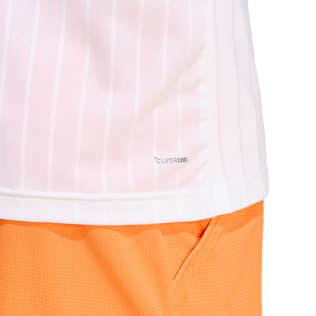 Close-up detail of the adidas Climacool Freelift Pro T-Shirt White, showing the lightweight white fabric texture, subtle vertical stripe pattern and lower side detail above bright orange shorts.