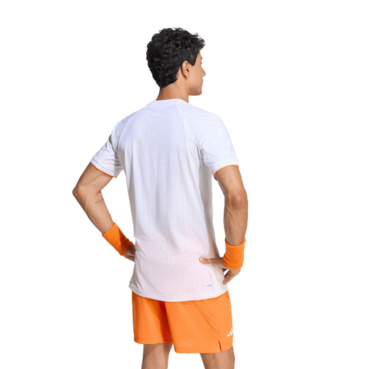 Back view of a male model wearing the adidas Climacool Freelift Pro T-Shirt White with orange shorts, showing the clean rear design and sporty fit.