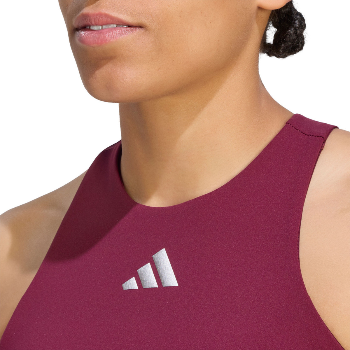 Close-up front detail of the adidas Silver Y-Tank, highlighting the sleeveless neckline, smooth fabric and silver adidas chest logo.