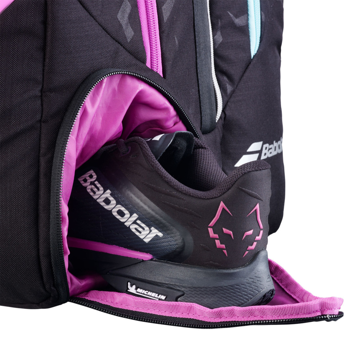 Open compartment view of the Babolat Pro Juan Lebrón Racketbag 2027, showing the interior storage space, pink lining and one of the zipped sections opened wide.