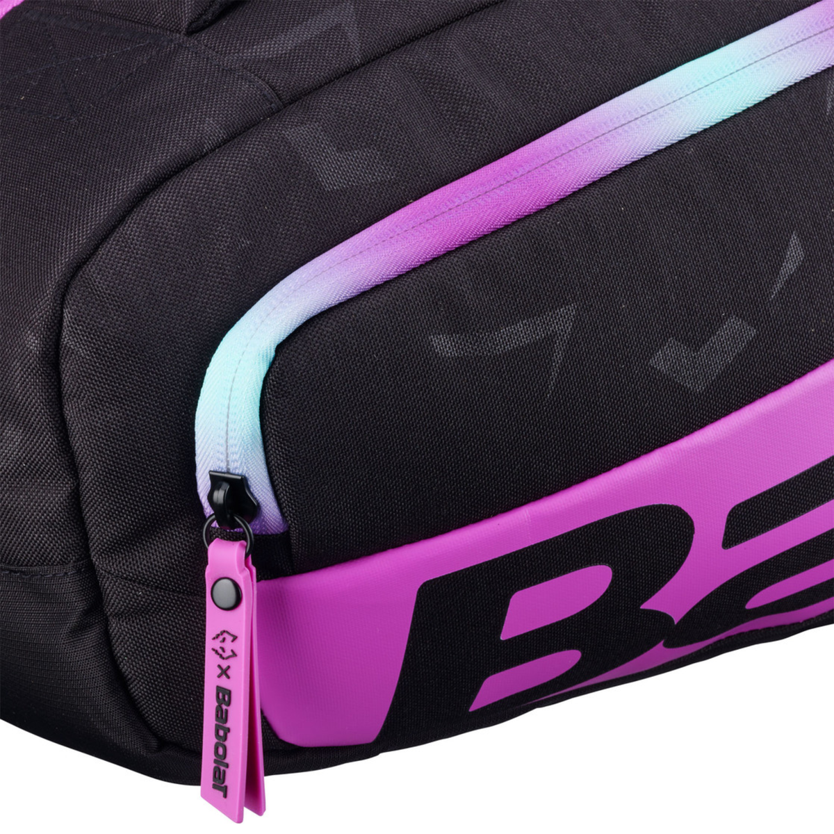 Close-up of the Babolat Pro Juan Lebrón Racketbag 2027, showing a zipped compartment with pink trim, black fabric and large Babolat branding detail.