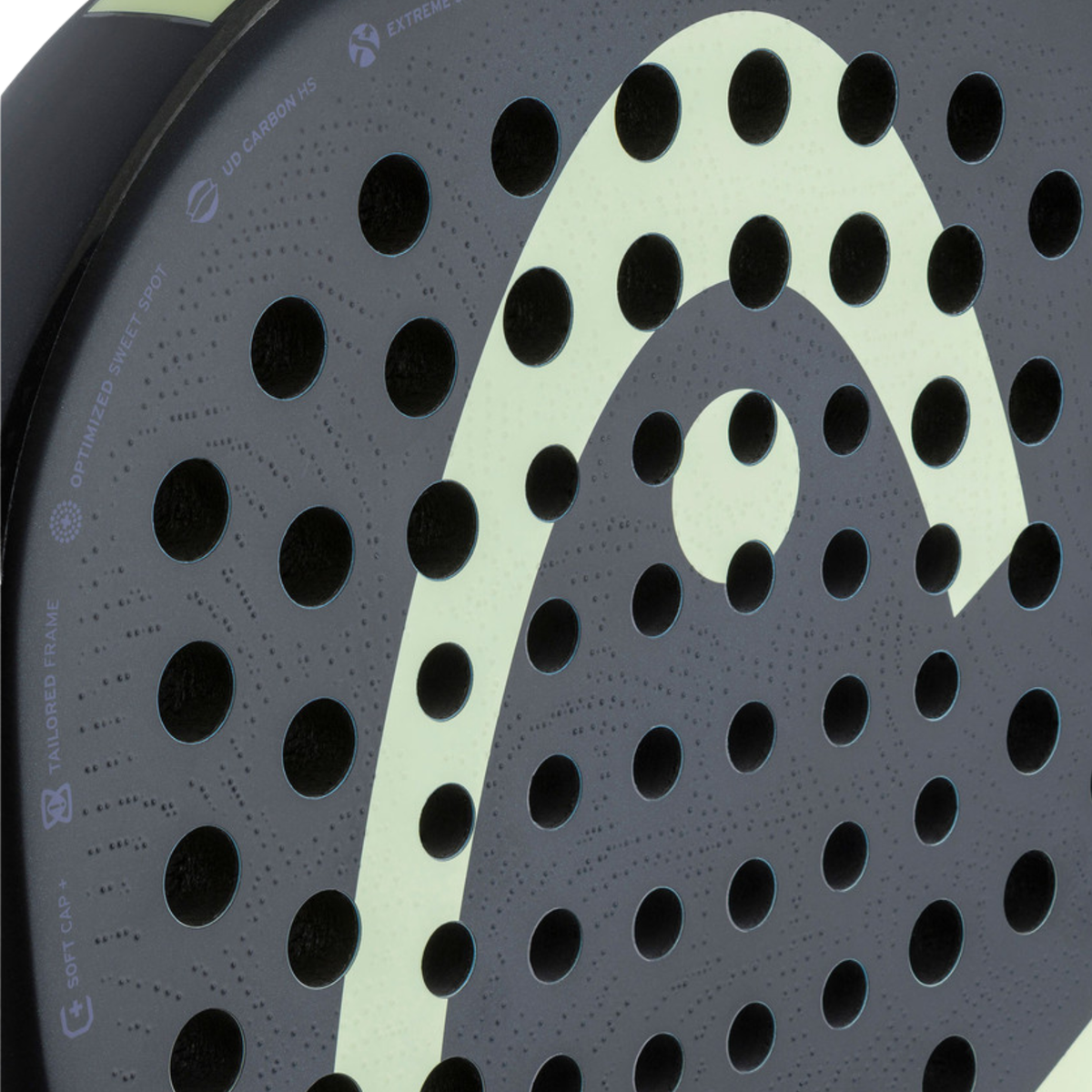 Detailed close-up of the HEAD Extreme Pro 2026 padel racket face, showing the black textured surface, multiple holes and large light green HEAD logo.