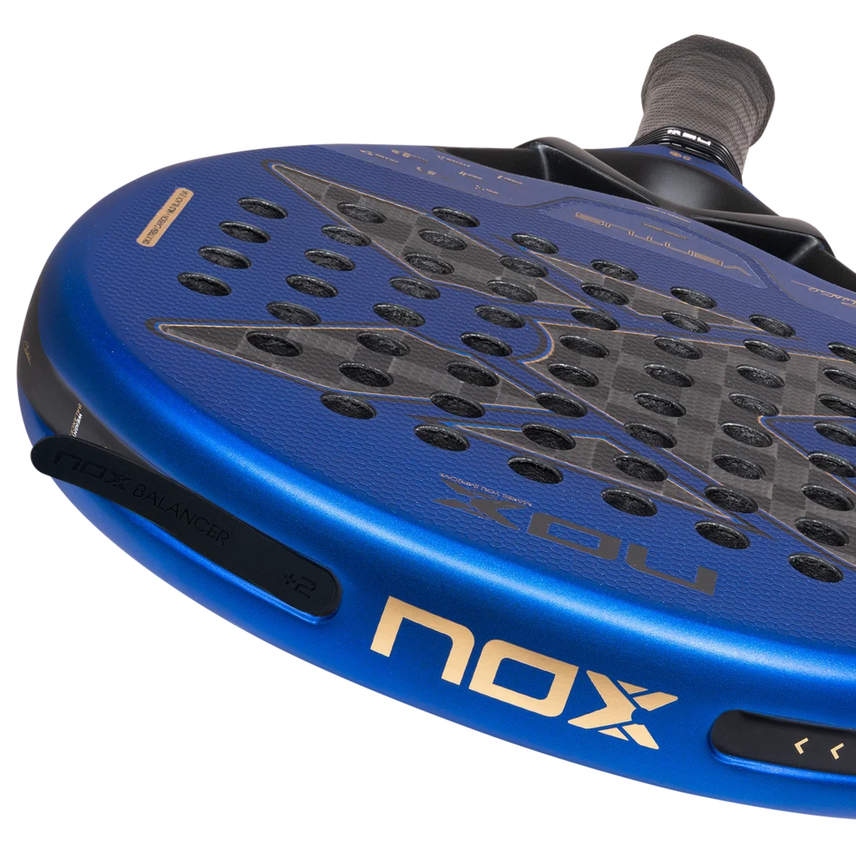 Detailed close-up of the NOX Ventus Hybrid 12K Xtrem Edu Alonso 2027 padel racket frame, showing the black Nox Balancer weight system, metallic blue frame, gold Nox branding and grey carbon-style racket face.